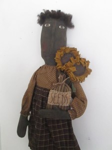 Sadie is 30" tall. She holds 2 sunflowers on sticks and a bag with "SEEDS" hand-stitched on a piece of muslin on the front. 