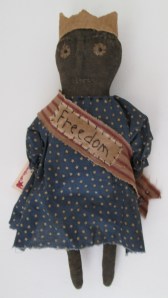 13" Libby wears a banner with the word "Freedom" hand-stitched on it. The banner is held together with a rusty bell. $33.00
