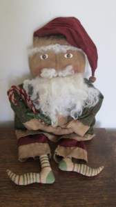 Santa is 22" tall and made of grungy muslin. His sheep's wool beard and hair are sewn on - Never glued. His clothes are grubby flannel with grubby flannel trim hand-sewn on. $68.00