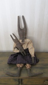 Beatrice is 26" tall and her baby (which is sewn securely in her arm) is 10" tall. They are ready for spring but are perfect to keep out all year. $42.00